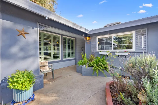 a house with a lot of flower plants