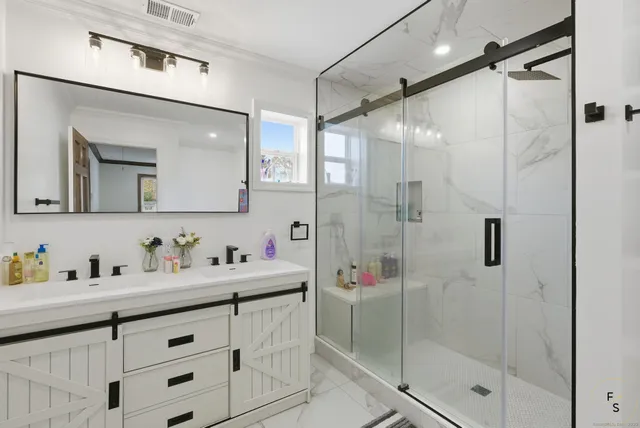 a bathroom with a shower sink and mirror