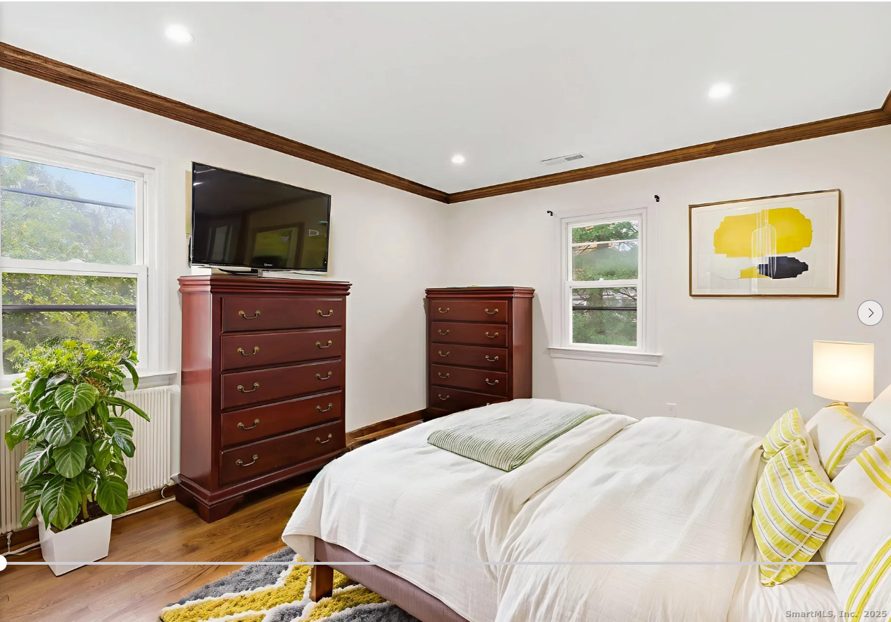 29 Priscilla Road Norwalk, CT 06850 - Photo 22 of 40 a bedroom with a bed and a television