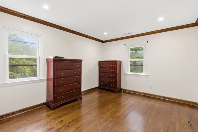 an empty room with windows and closet