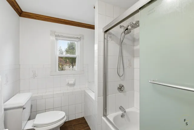 a bathroom with a shower a toilet and a shower