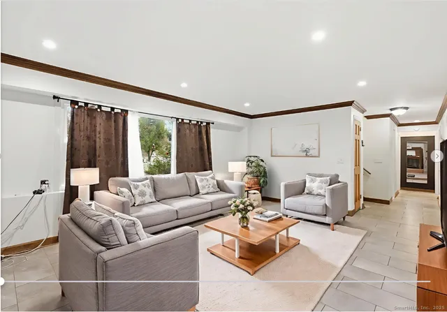 a living room with furniture and a large window