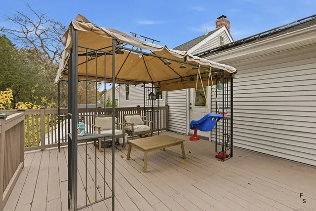 a view of a roof deck with wooden floor and fence