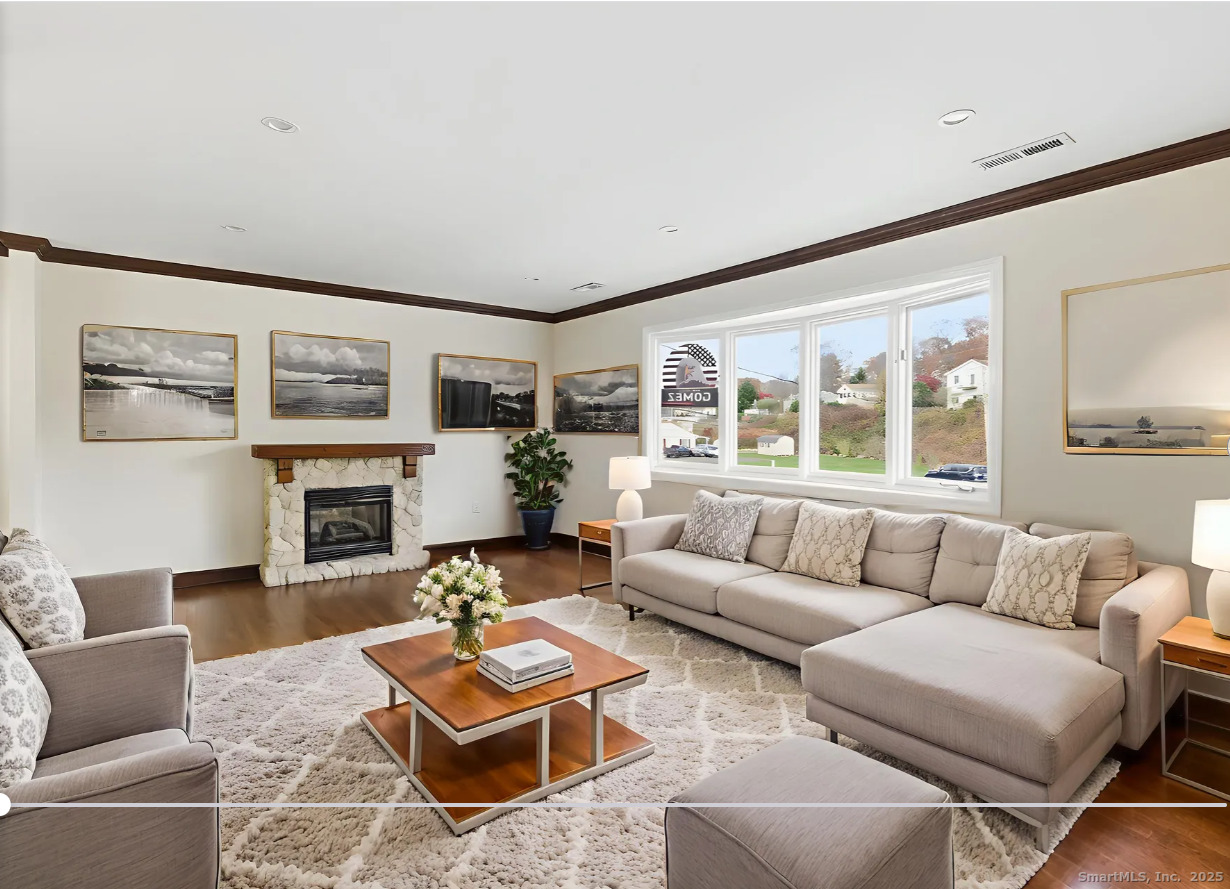 29 Priscilla Road Norwalk, CT 06850 - Photo 4 of 40 a living room with furniture a fireplace and a large window