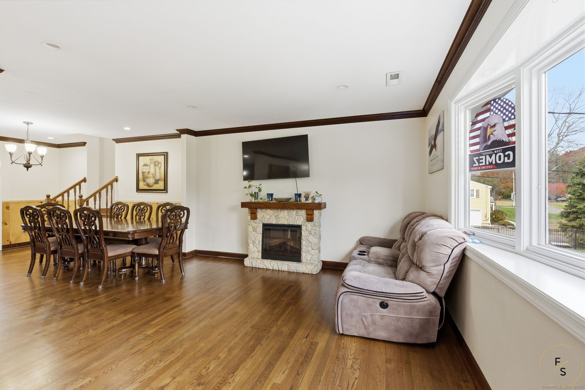 29 Priscilla Road Norwalk, CT 06850 - Photo 7 of 40 a living room with furniture a fireplace and a flat screen tv