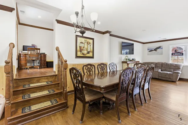 a dining room with furniture and wooden floor