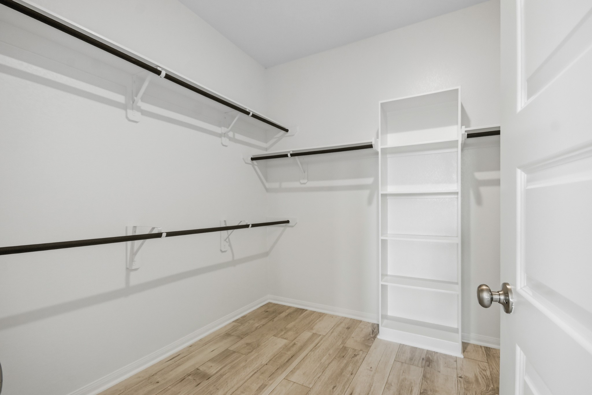 10723 Clfs Vw Drive Rosharon, TX 77583 - Photo 22 of 50 Primary bedroom closet has multiple racks and built in cabinet, no carpet here!
