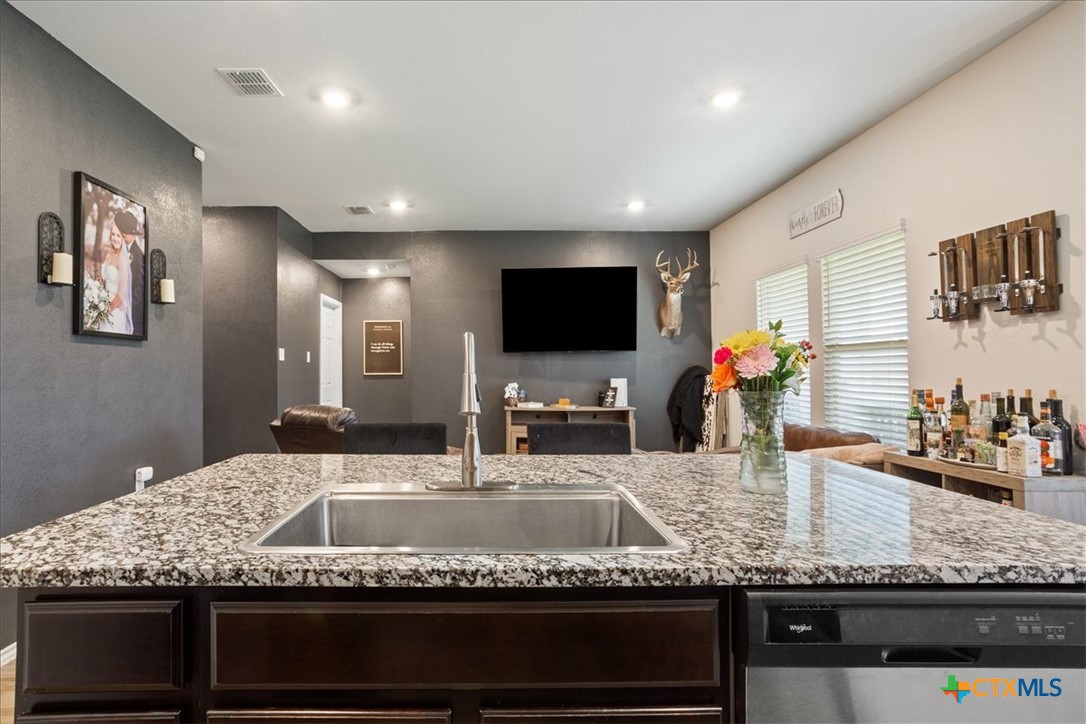 1000 Velvet Court Troy, TX 76579 - Photo 13 of 25 a kitchen with granite countertop kitchen island stainless steel appliances a sink and a counter top