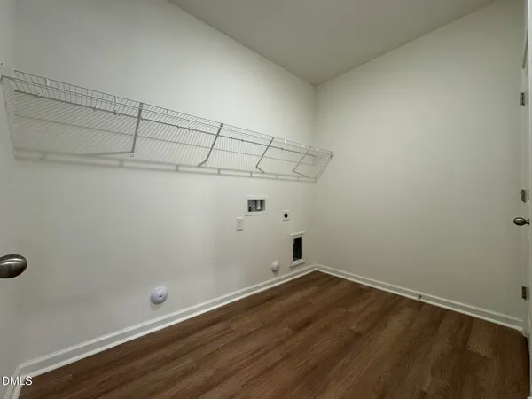 a view of a room with wooden floor