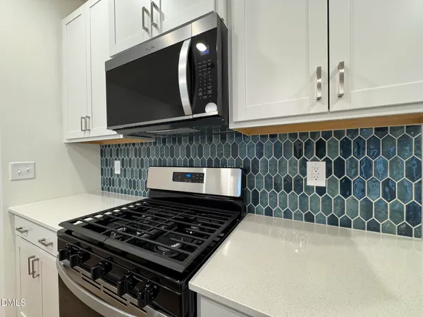 a kitchen with a stove and a microwave