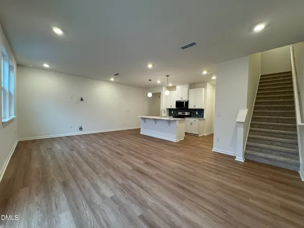 a view of kitchen and hall with wooden floor