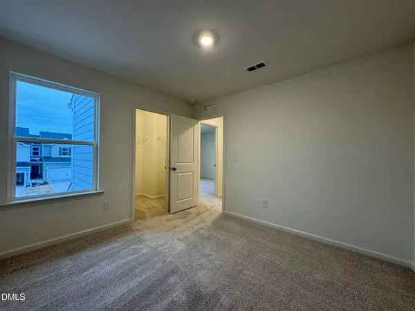 an empty room with a empty space and windows