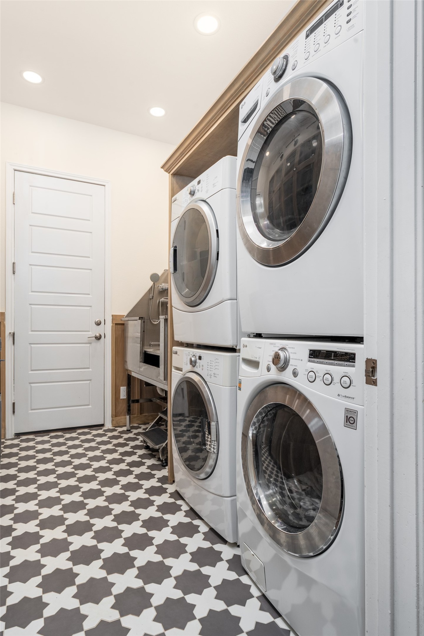 1225 Grassy Field Road Austin, TX 78737 - Photo 18 of 40 Laundry room featuring stacked washer / drying machine, tile patterned floors, washing machine and clothes dryer, and recessed lighting