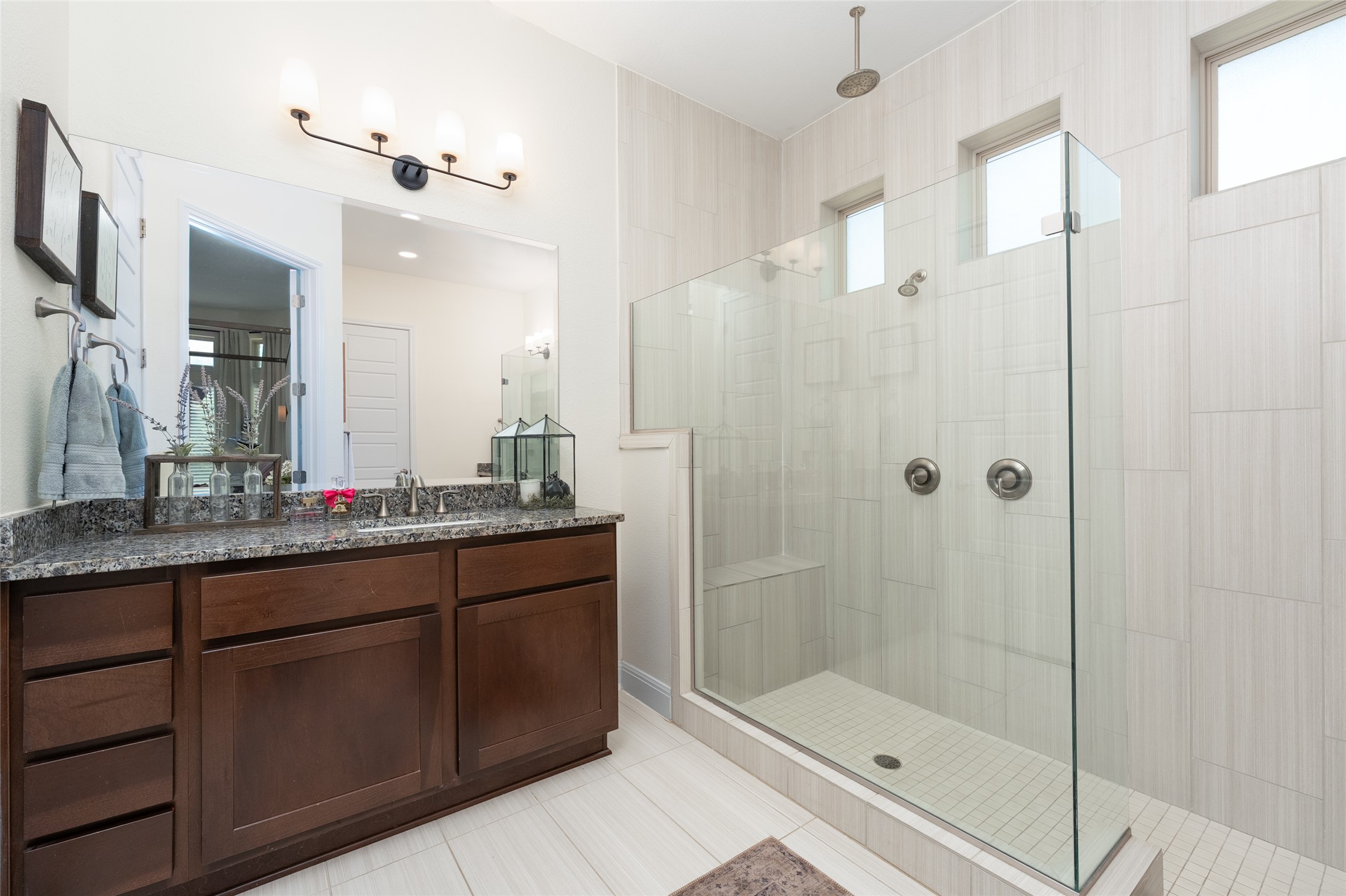 1225 Grassy Field Road Austin, TX 78737 - Photo 30 of 40 Bathroom with tiled shower, vanity, and tile patterned flooring