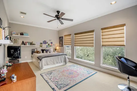 a bathroom with a granite countertop toilet sink and mirror