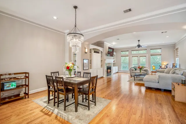 a kitchen with stainless steel appliances kitchen island wooden floors and white cabinets