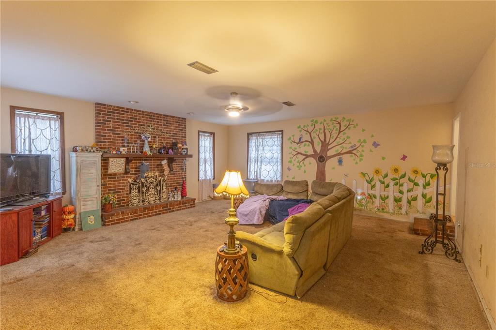 2641 Southeast 45th Street Ocala, FL 34480 - Photo 11 of 36 a living room with furniture and a flat screen tv