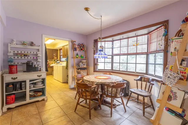 a view of a dining room with furniture and a window