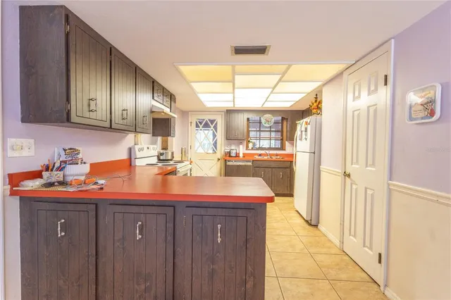 a kitchen with stainless steel appliances granite countertop a sink and cabinets