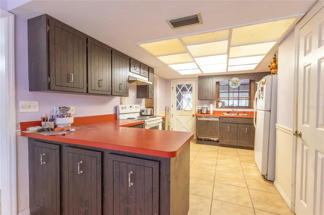 a kitchen with a sink cabinets and window