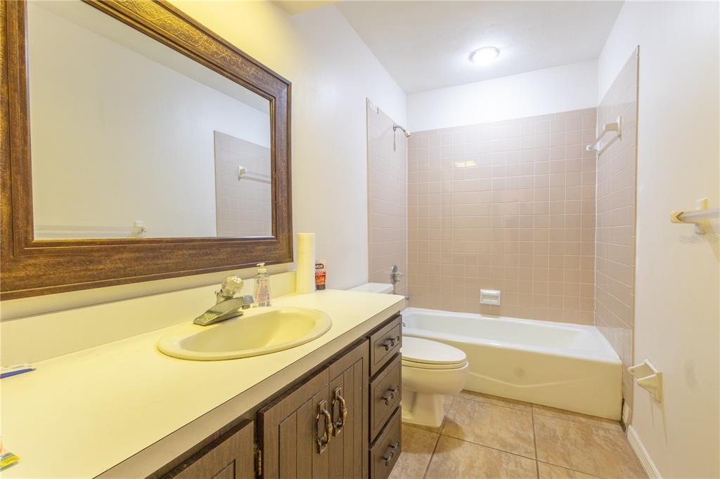 2641 Southeast 45th Street Ocala, FL 34480 - Photo 22 of 36 a bathroom with a sink a toilet and a bathtub