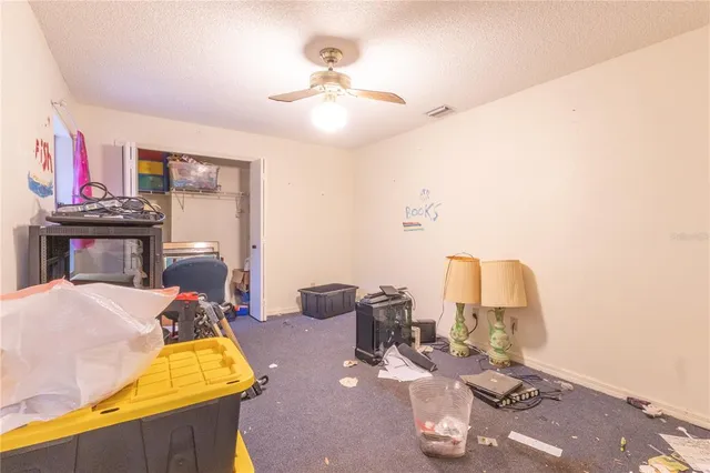 a room with gym equipment and a chandelier