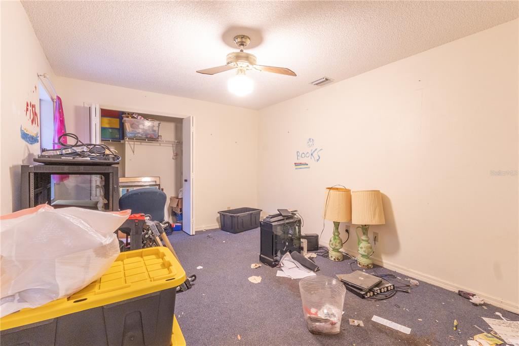 2641 Southeast 45th Street Ocala, FL 34480 - Photo 28 of 36 a room with gym equipment and a chandelier