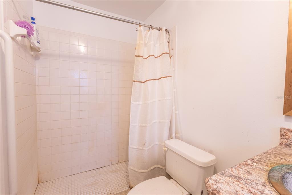 2641 Southeast 45th Street Ocala, FL 34480 - Photo 30 of 36 a bathroom with a shower a toilet and sink