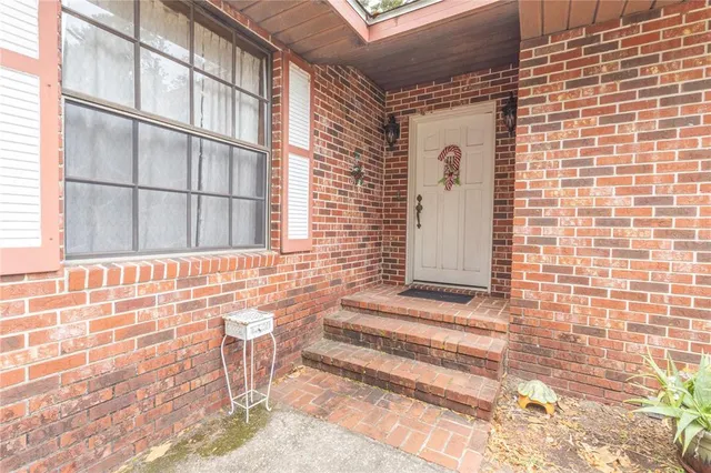 a view of a door with a chair and table and chair