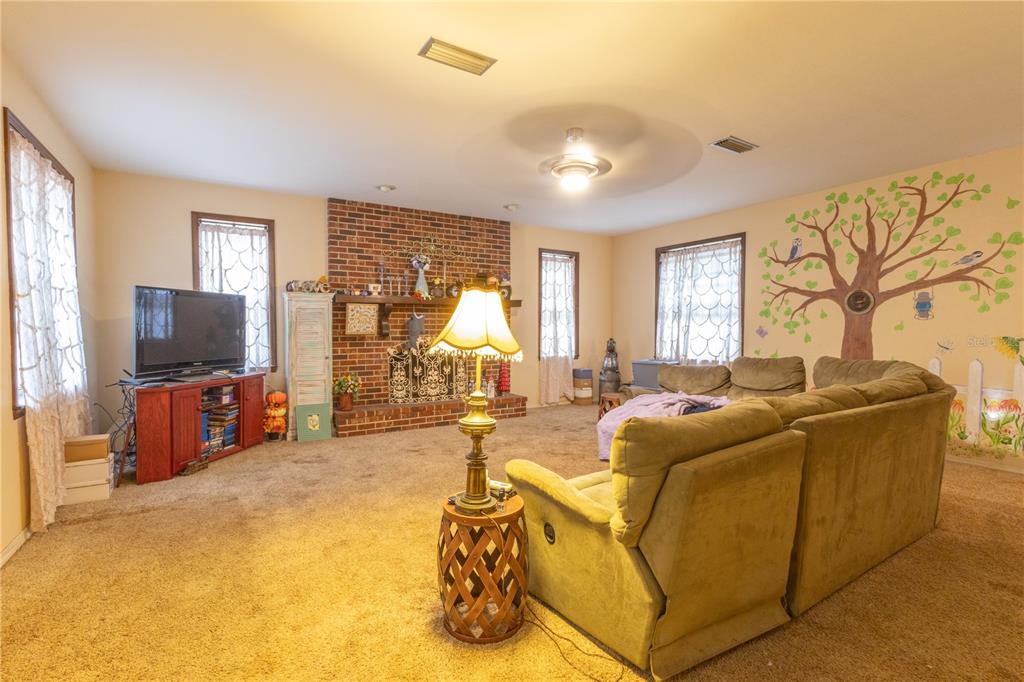 2641 Southeast 45th Street Ocala, FL 34480 - Photo 9 of 36 a living room with furniture and a flat screen tv