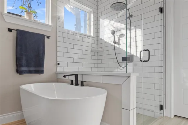 a bathroom with a sink toilet tub and shower