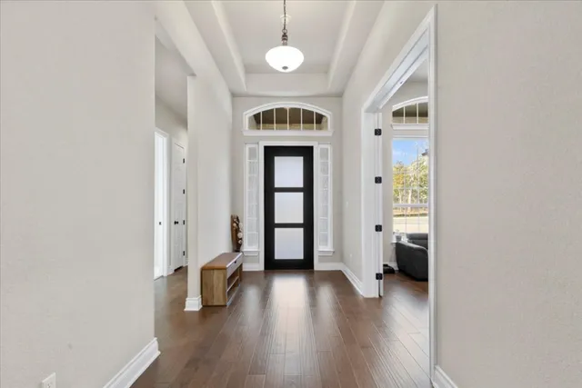 a living room with furniture and a dining table with kitchen view