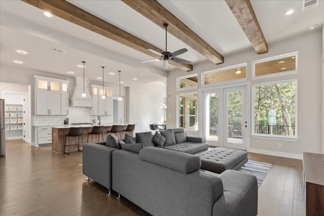 a kitchen with stainless steel appliances a dining table chairs and sink