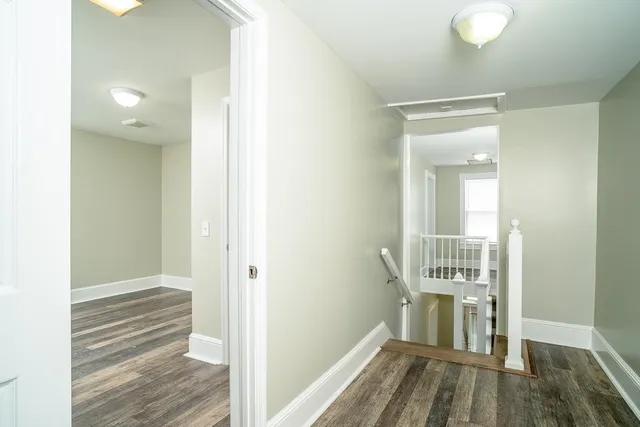 a view of an empty room with window and ceiling fan