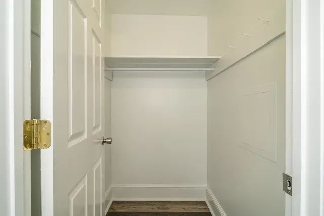 a bathroom with a window a shower and a sink