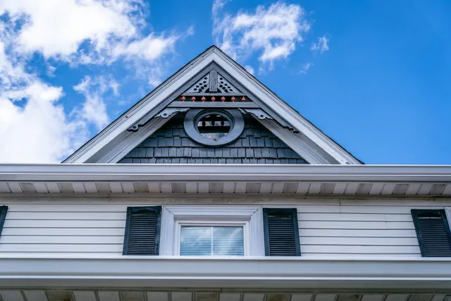 a view of a house with backyard and a tree