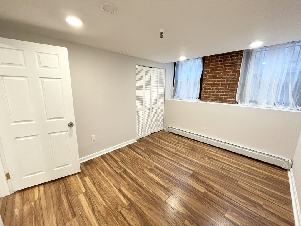 39 Hemenway Street, Unit 26 Boston, MA 02115 - Photo 11 of 27 a view of a room with wooden floor and cabinet