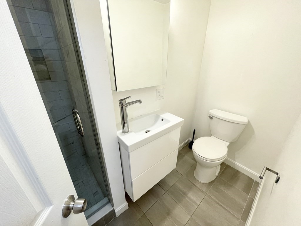 39 Hemenway Street, Unit 26 Boston, MA 02115 - Photo 22 of 27 a white toilet sitting next to a small sink