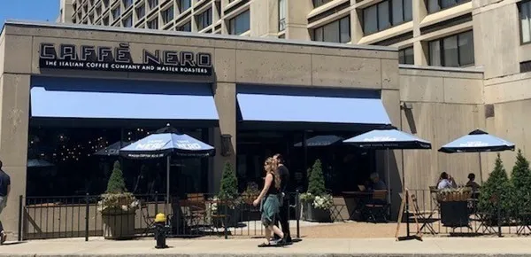 a group of people walking down a street sign