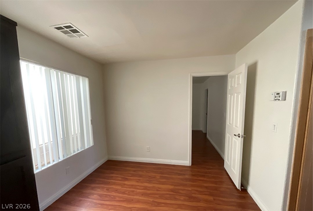 7203 Cestrum Road Las Vegas, NV 89113 - Photo 17 of 22 Gleaming hardwood floors and a wide window define this versatile interior space.