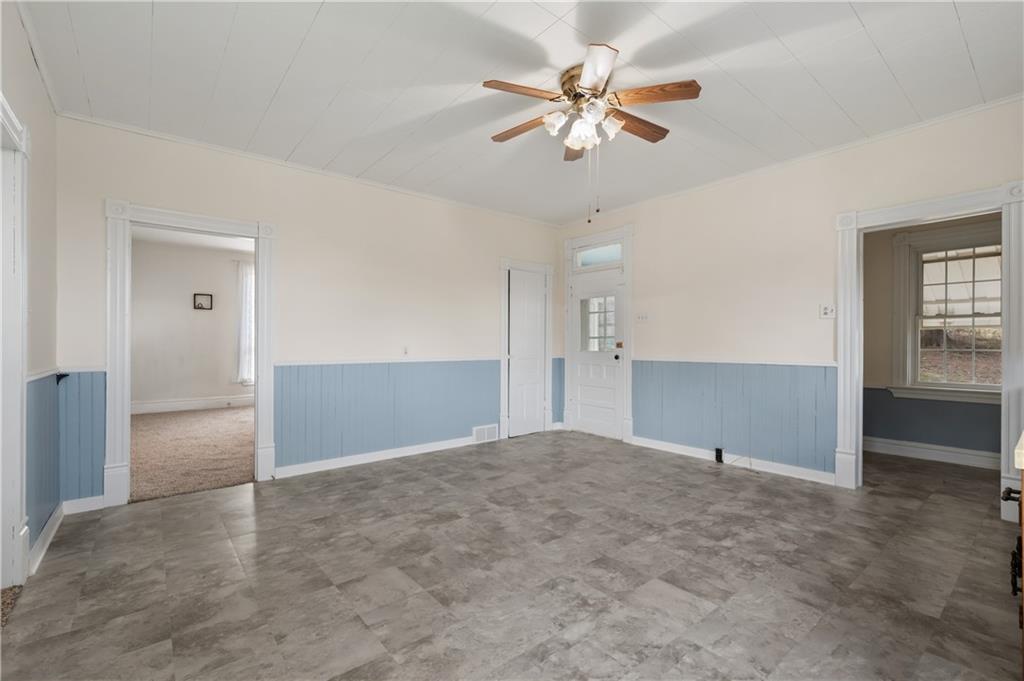 272 Shaffer Road Beaver Falls, PA 15010 - Photo 15 of 38 an empty room with fan and way to kitchen
