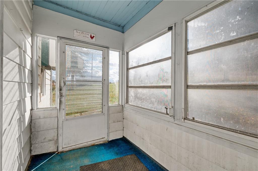 272 Shaffer Road Beaver Falls, PA 15010 - Photo 17 of 38 a view of an empty room with wooden floor and a window