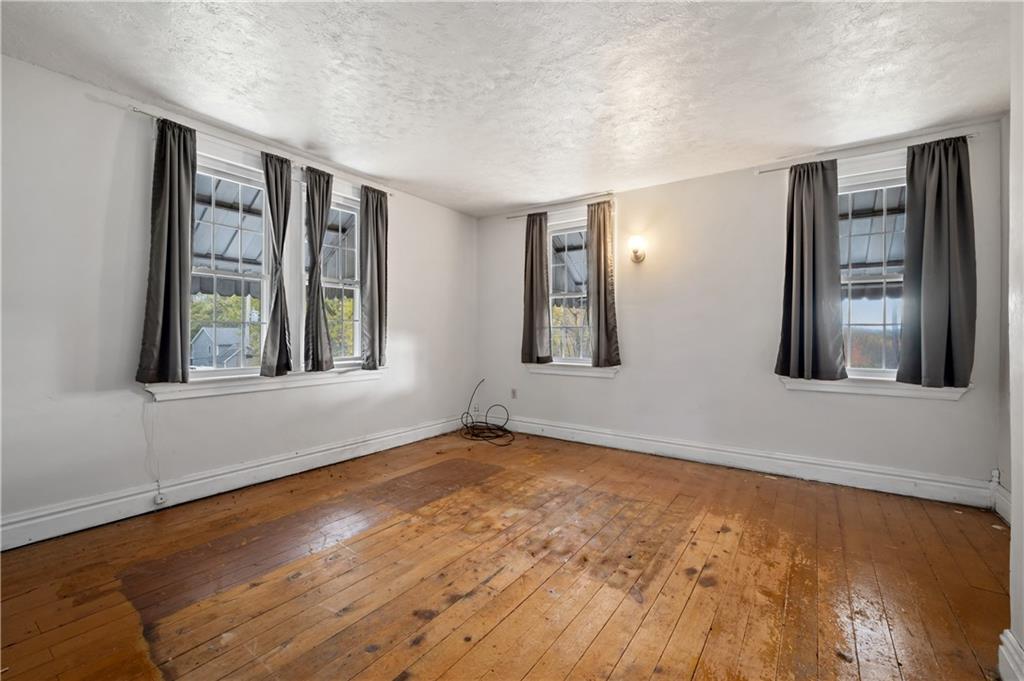 272 Shaffer Road Beaver Falls, PA 15010 - Photo 24 of 38 a view of an empty room with window and wooden floor