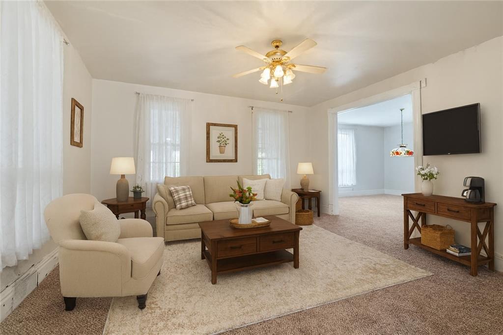 272 Shaffer Road Beaver Falls, PA 15010 - Photo 6 of 38 a living room with furniture a chandelier and a flat screen tv