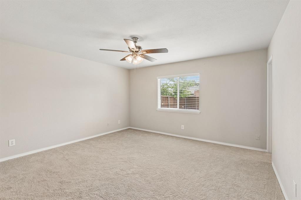5620 Perrin Street The Colony, TX 75056 - Photo 14 of 31 an empty room with a window and a ceiling fan