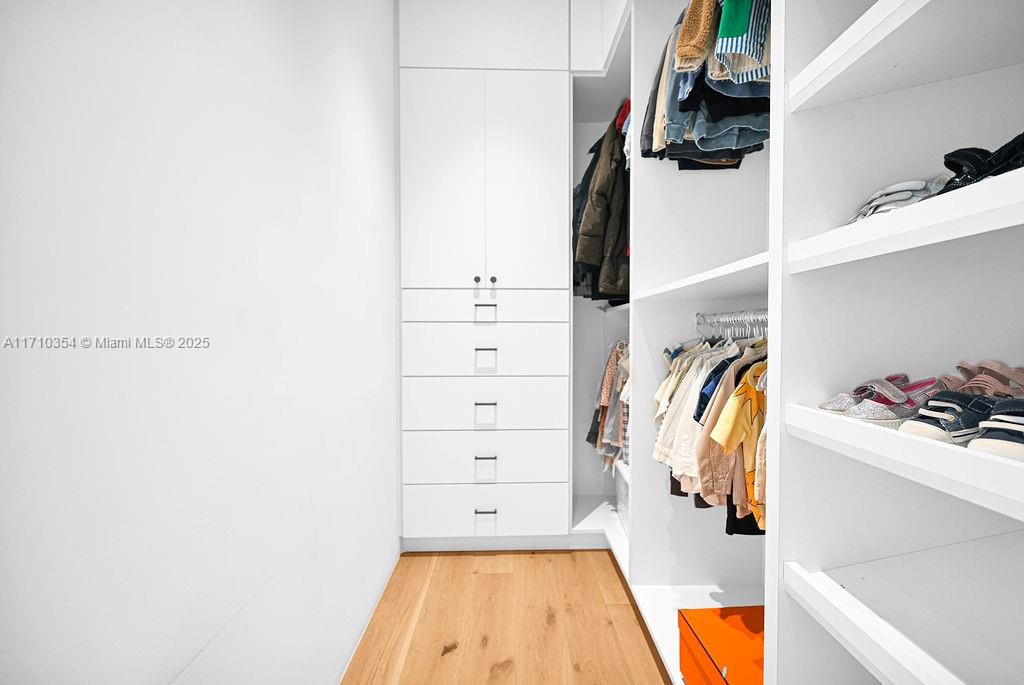 364 Southwest 30th Road Miami, FL 33129 - Photo 25 of 38 a view of walk in closet with clothes and shoes