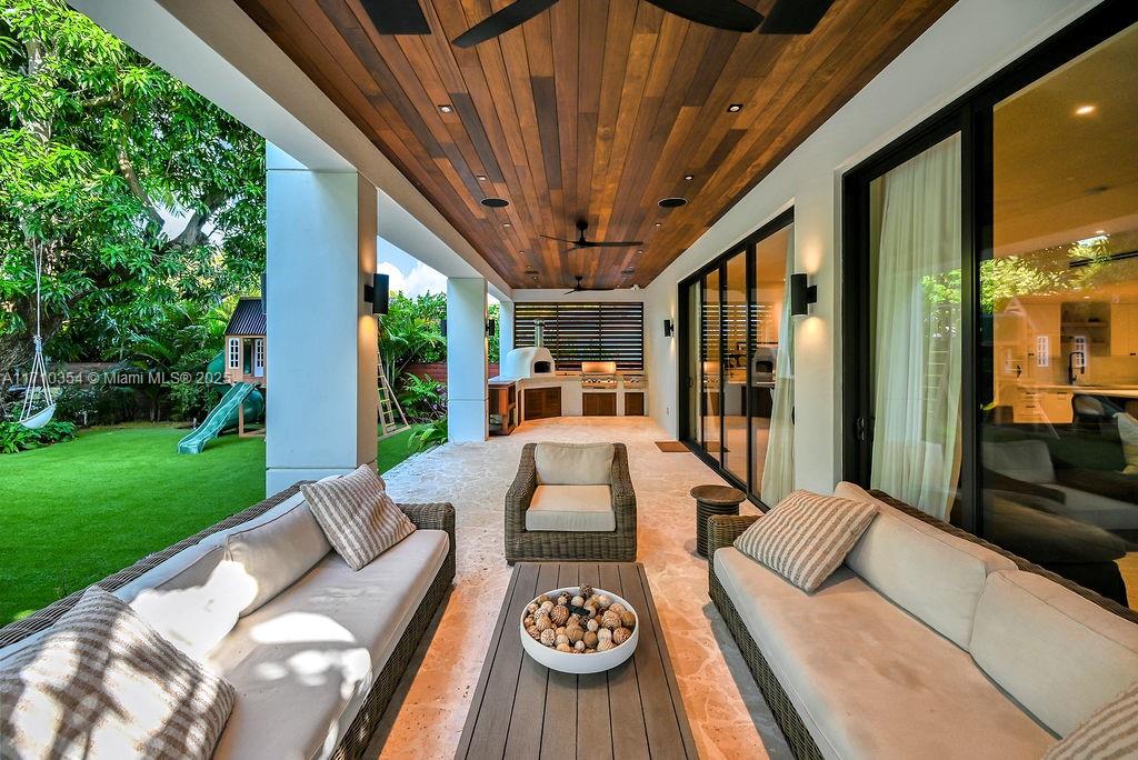 364 Southwest 30th Road Miami, FL 33129 - Photo 32 of 38 a view of a patio with couches table and chairs with a big yard