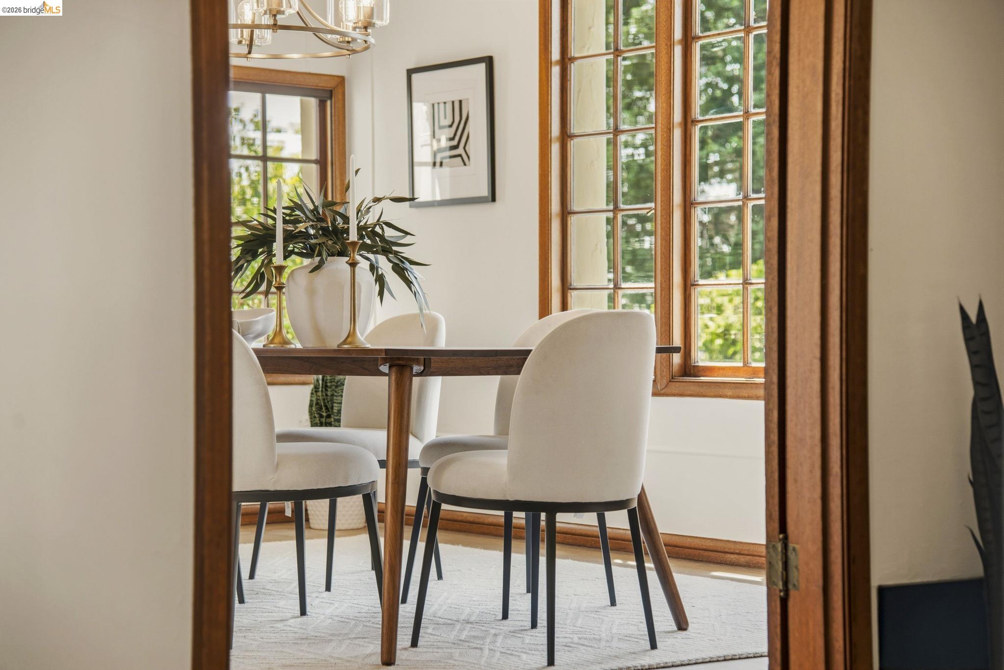 1087 Hubert Road Oakland, CA 94610 - Photo 49 of 67 Dining area featuring expansive grid-pane windows with natural wood trim