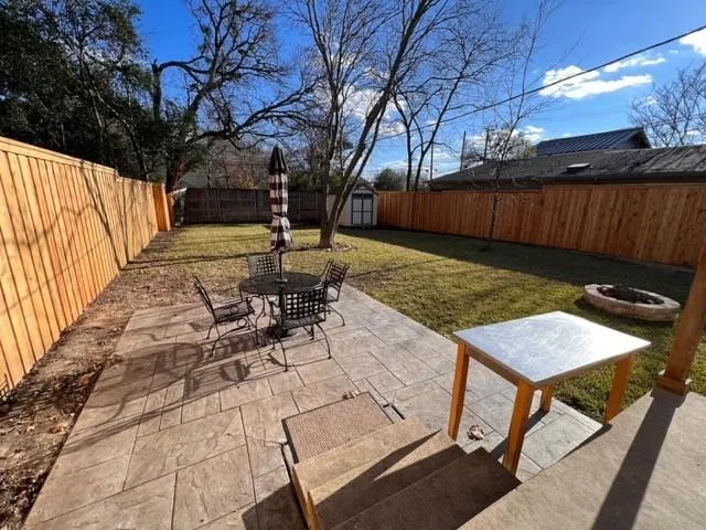 a view of backyard with sitting area