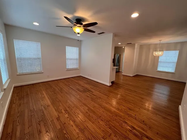 a view of an empty room and wooden floor